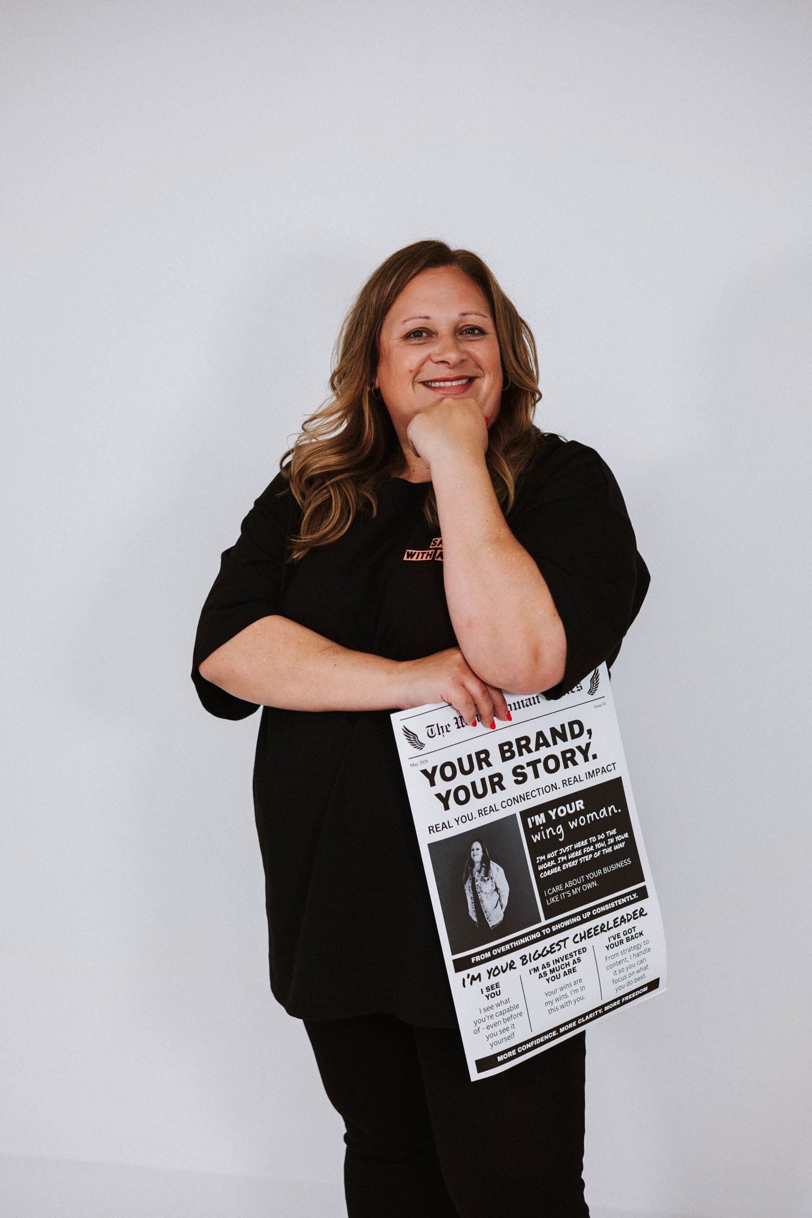 Jo smiling, holding a newspaper headed Your brand, your story.